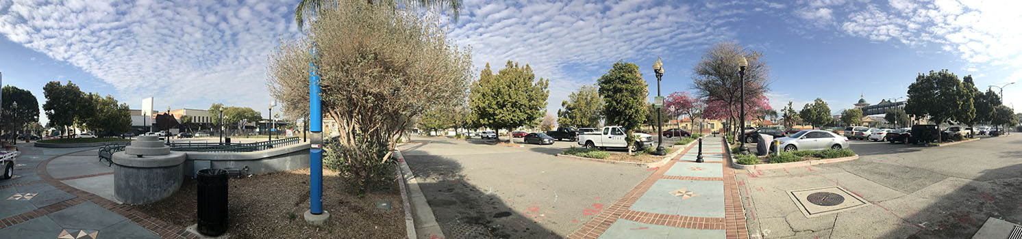 Clean roads, benches, and neat parking lot with trees in Pomona, California